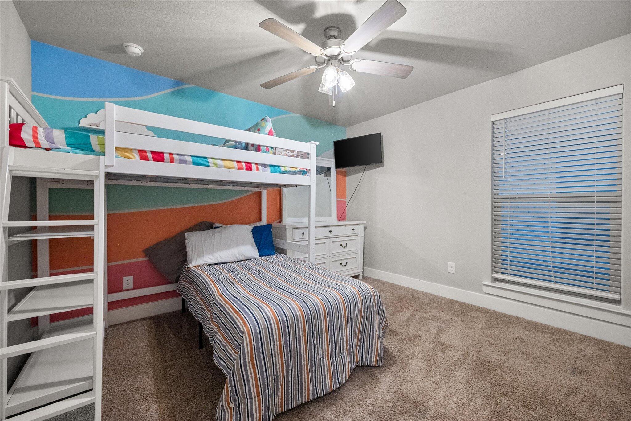 7449 31st Street Lubbock, TX 79407 - Photo 17 of 23 a bedroom with a bed and a ceiling fan