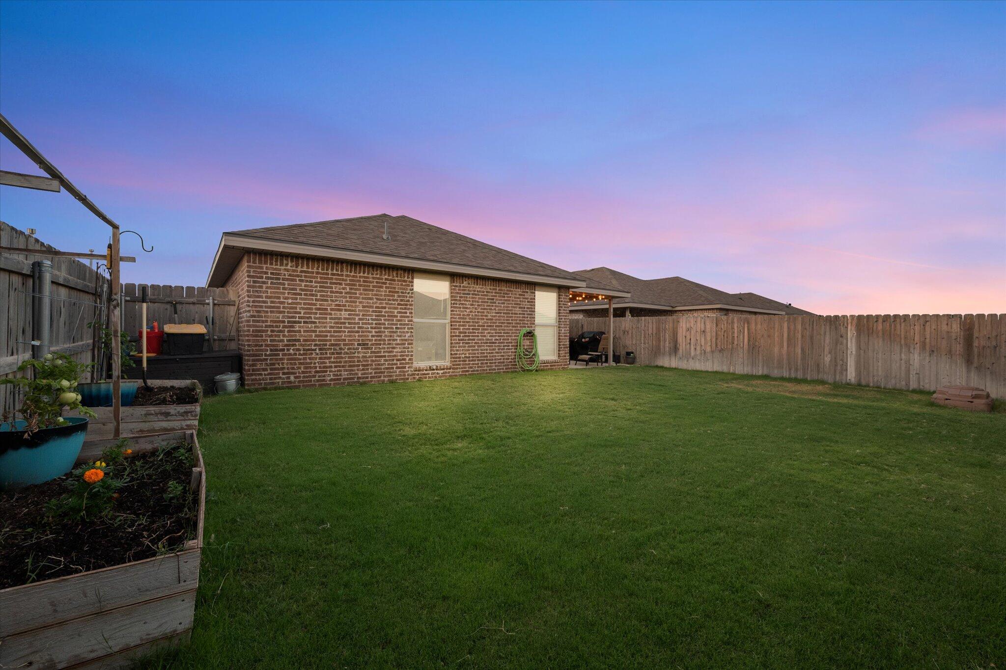 7449 31st Street Lubbock, TX 79407 - Photo 23 of 23 a view of a backyard with potted plants