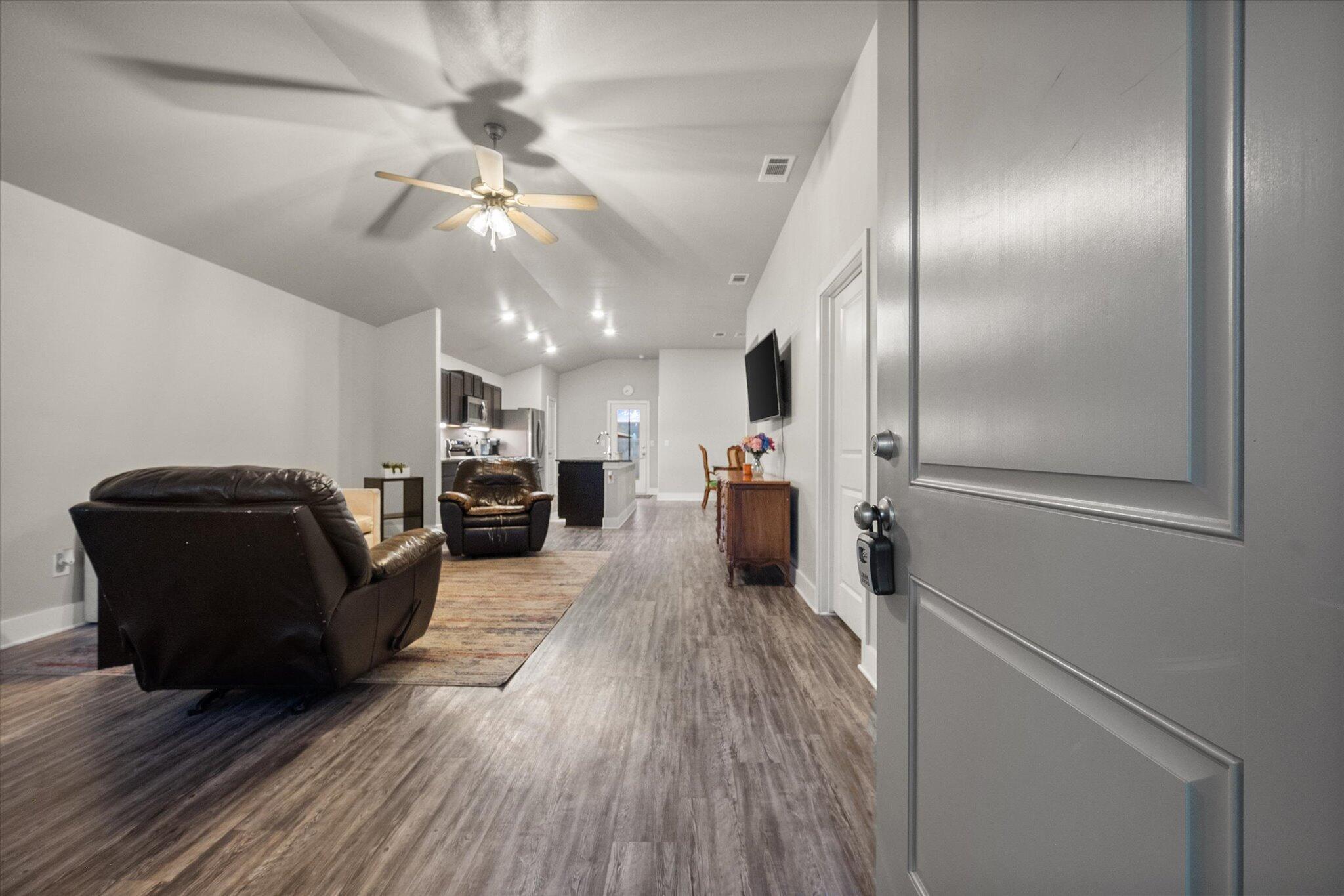 7449 31st Street Lubbock, TX 79407 - Photo 3 of 23 a living room with furniture and a wooden floor