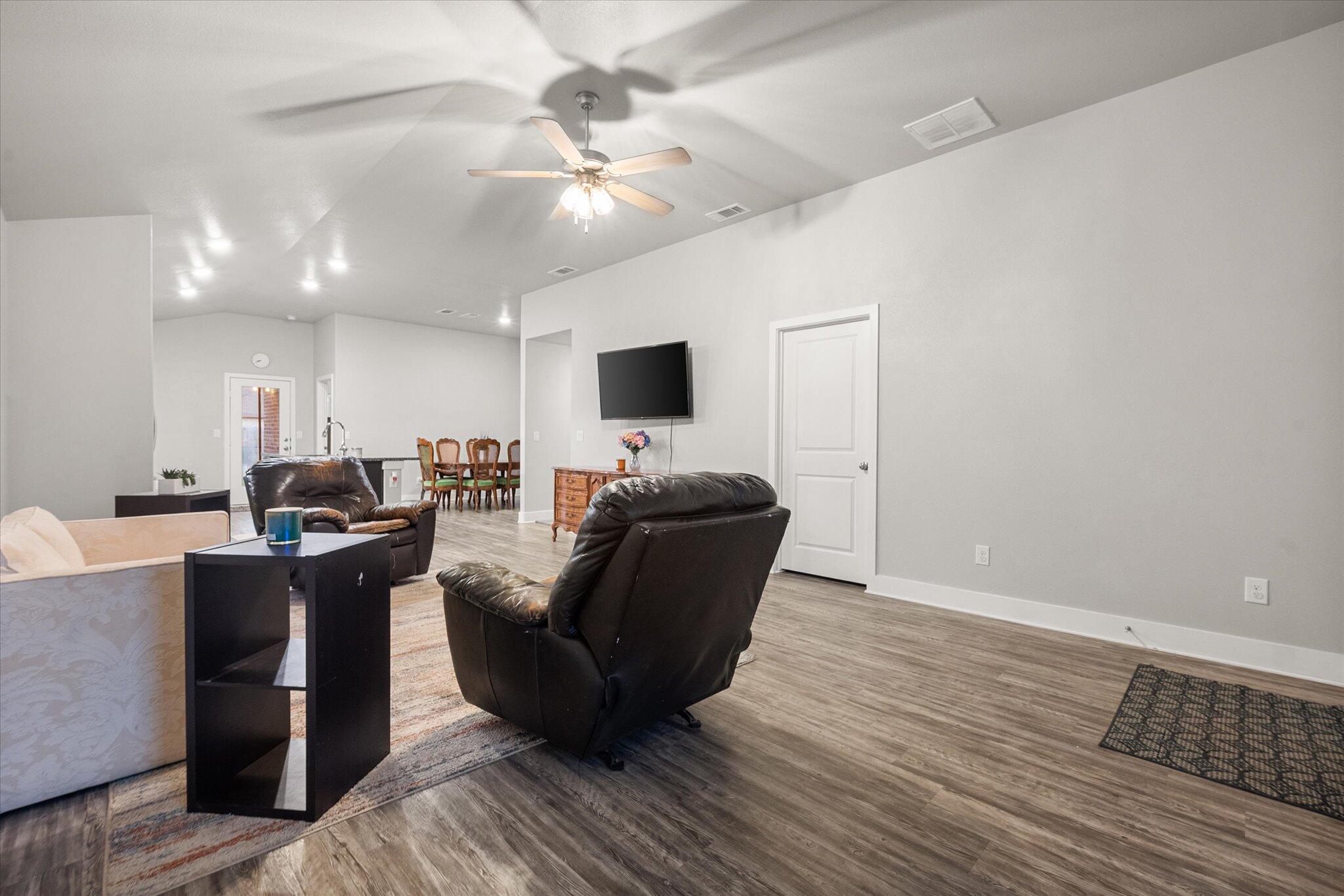 7449 31st Street Lubbock, TX 79407 - Photo 5 of 23 a living room with furniture and a flat screen tv