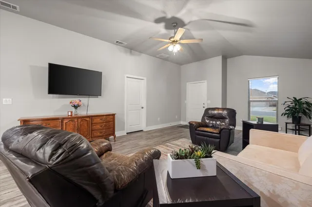 a living room with furniture and a flat screen tv