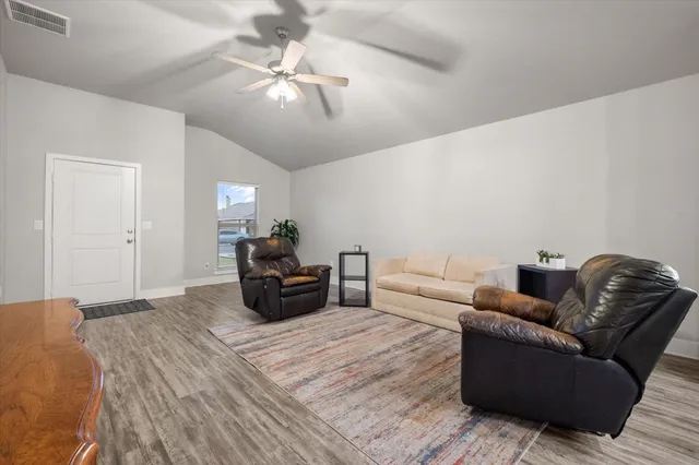 a bedroom with furniture and a ceiling fan