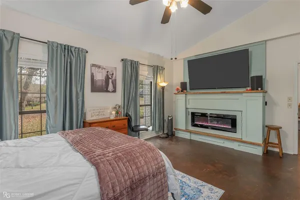 a bedroom with a bed and a fireplace