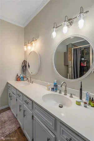 a bathroom with double vanity sinks and a mirror