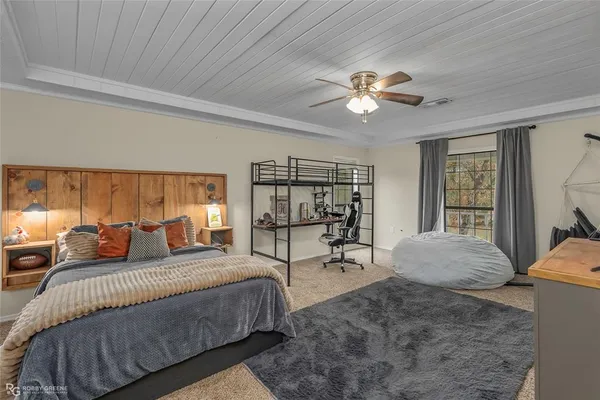 a living room with furniture and a ceiling fan