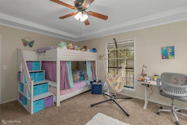 a bedroom with furniture and a ceiling fan