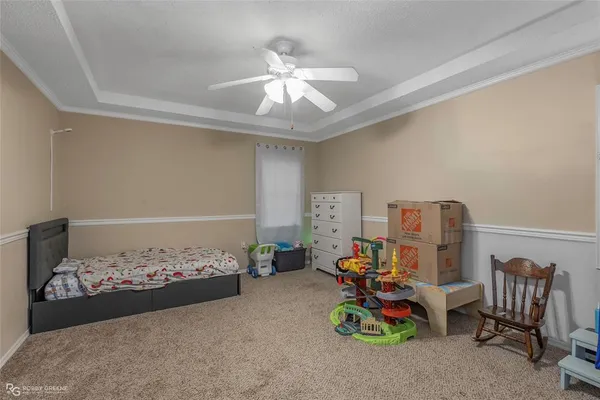 a bedroom with furniture and a fan