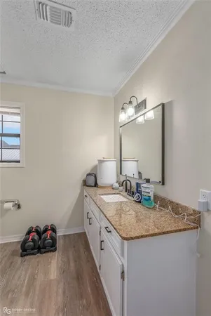 a spacious bathroom with a granite countertop double vanity and a sink