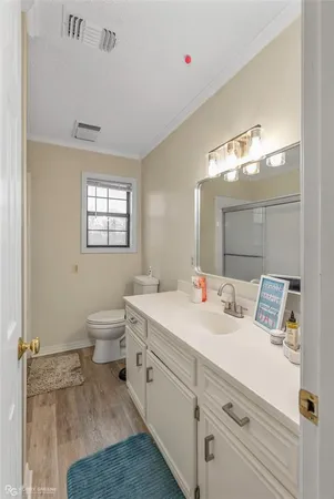 a spacious bathroom with a toilet sink and mirror