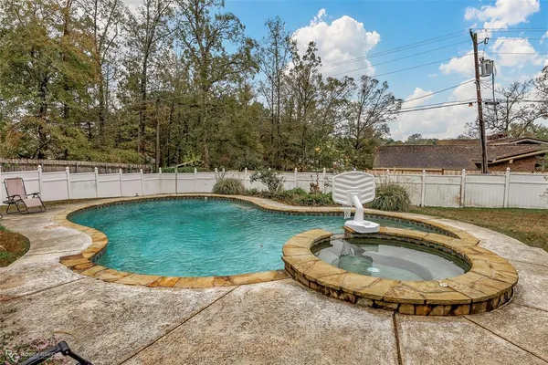 a view of a swimming pool with a patio