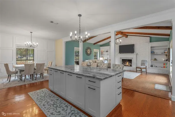 a kitchen with sink and view of living room