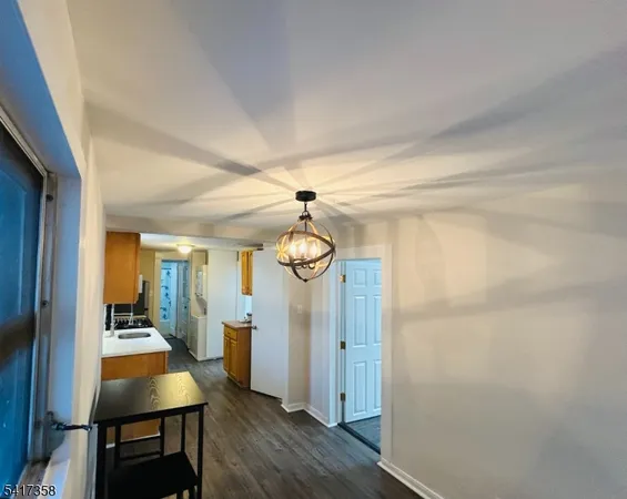 a view of a room with wooden floor and furniture