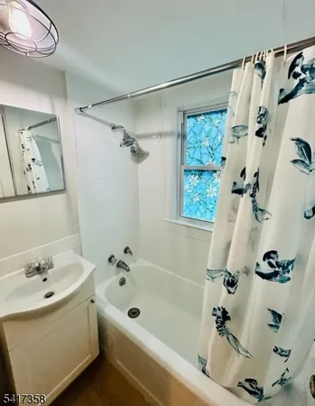 a bathroom with a bathtub a sink and a shower