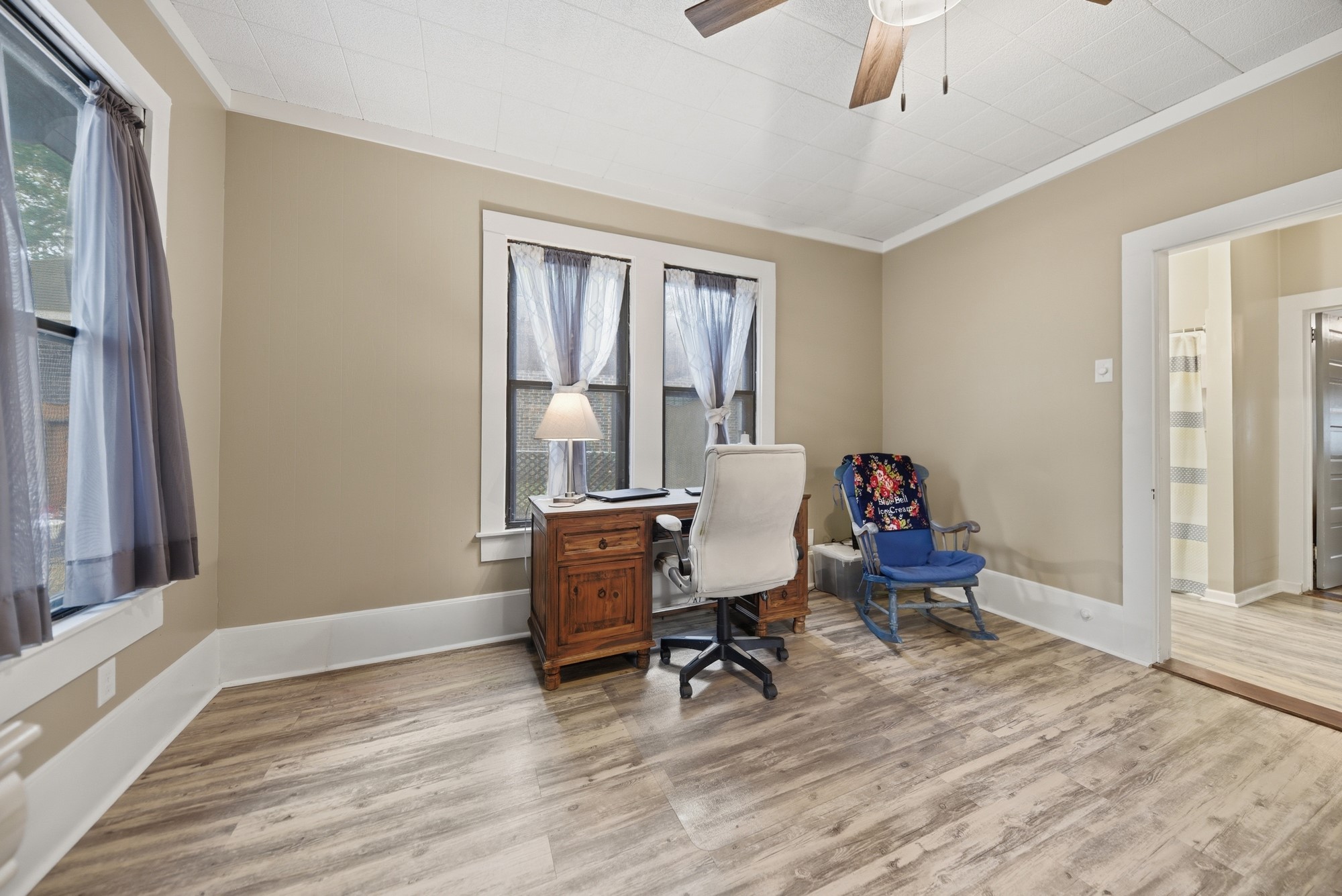 1501 South Austin Street Brenham, TX 77833 - Photo 17 of 36 a workspace with wooden floor and a window
