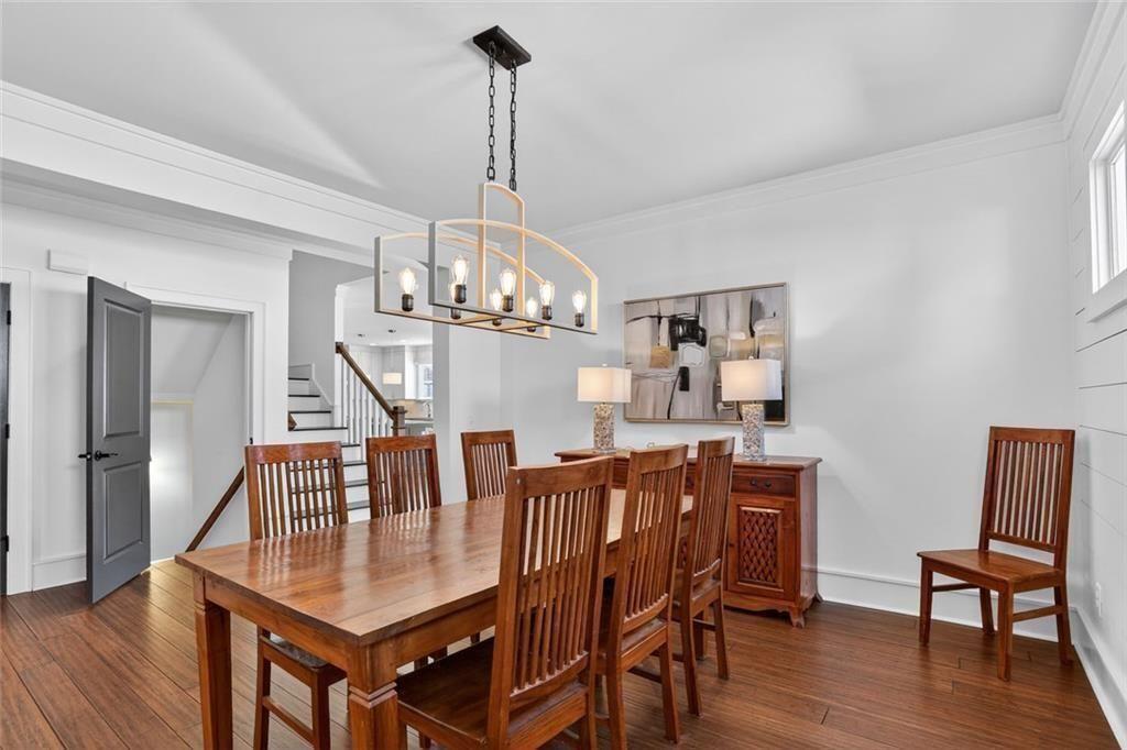1311 Conway Road Decatur, GA 30030 - Photo 15 of 49 a view of a dining room with furniture a chandelier and wooden floor