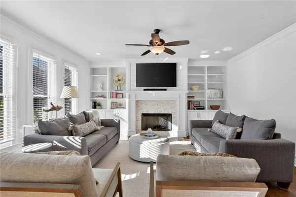 a living room with furniture a fireplace and a flat screen tv