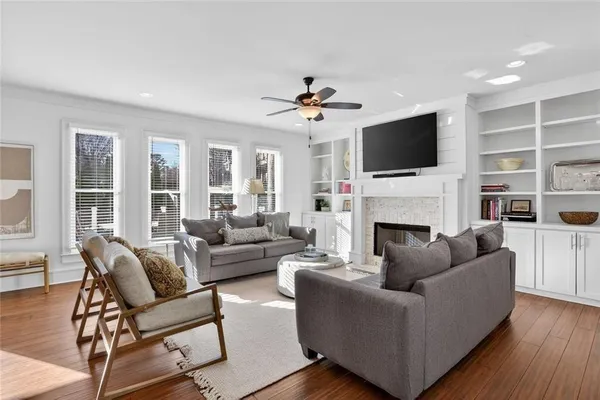 a living room with furniture a fireplace and a flat screen tv