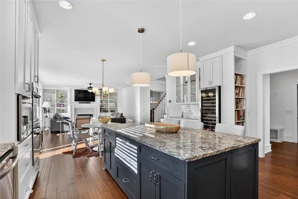 a kitchen with granite countertop a stove and chairs