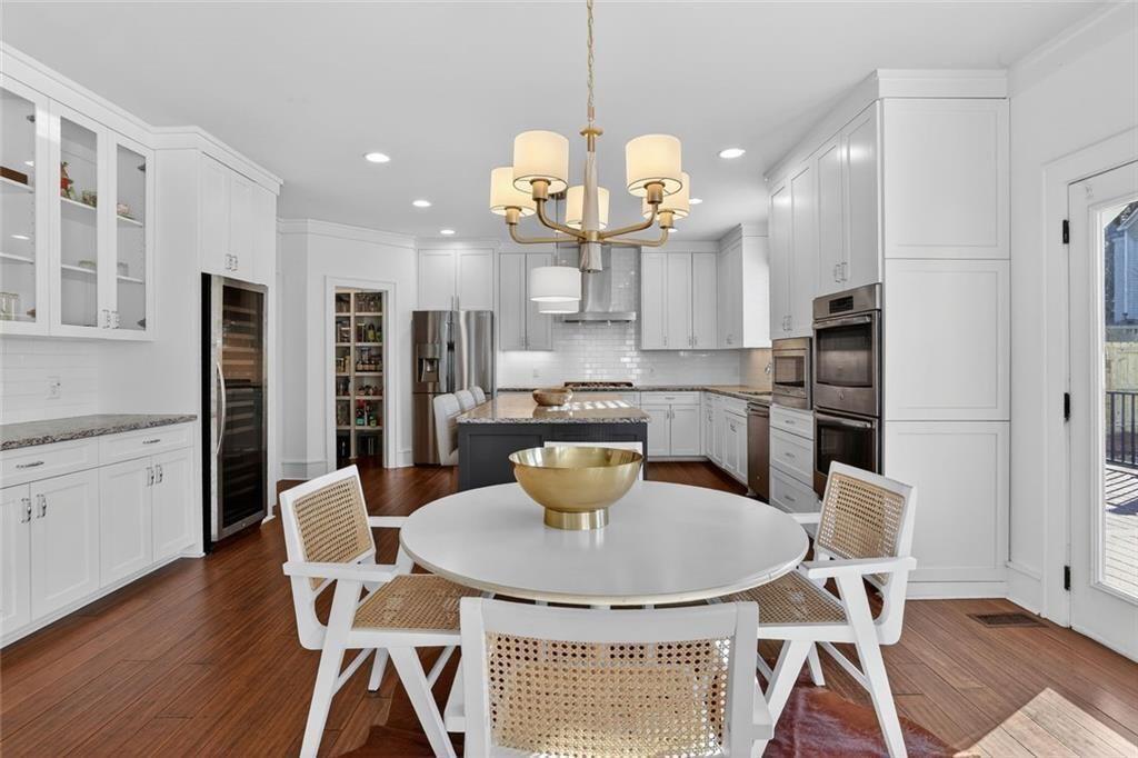 1311 Conway Road Decatur, GA 30030 - Photo 21 of 49 a kitchen with stainless steel appliances granite countertop a dining table chairs and a refrigerator