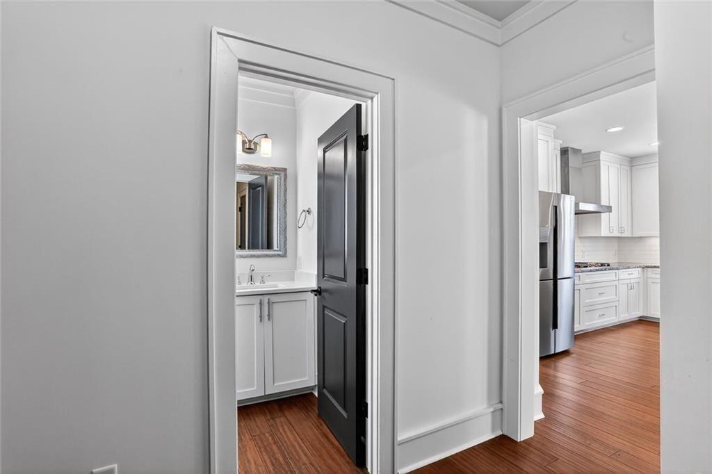 1311 Conway Road Decatur, GA 30030 - Photo 24 of 49 a view of a kitchen with a refrigerator and wooden floor
