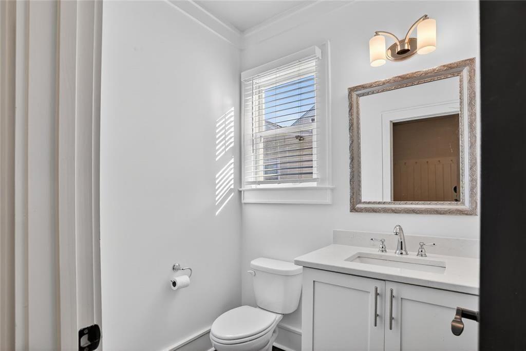 1311 Conway Road Decatur, GA 30030 - Photo 25 of 49 a bathroom with a toilet a sink and mirror