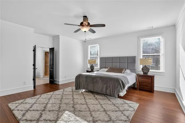 a bedroom with a large bed and a window