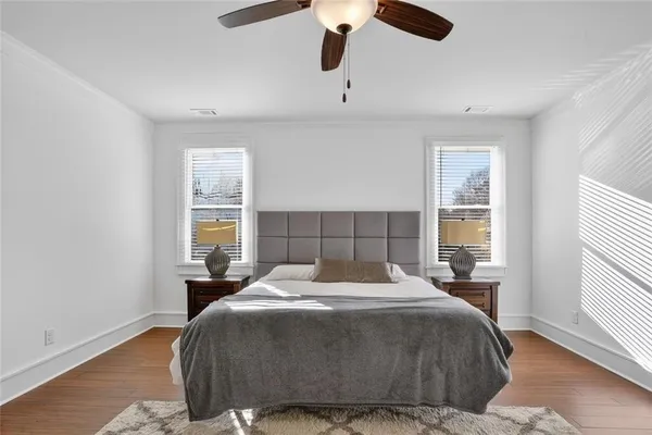 a bedroom with a large bed and a window