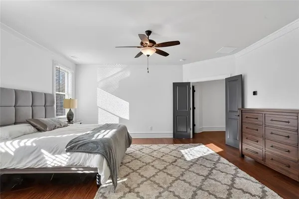 a bedroom with a bed and a ceiling fan
