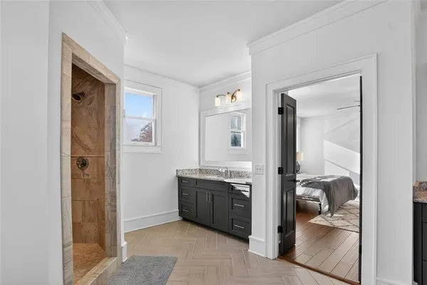 a view of a hallway to a livingroom and a livingroom