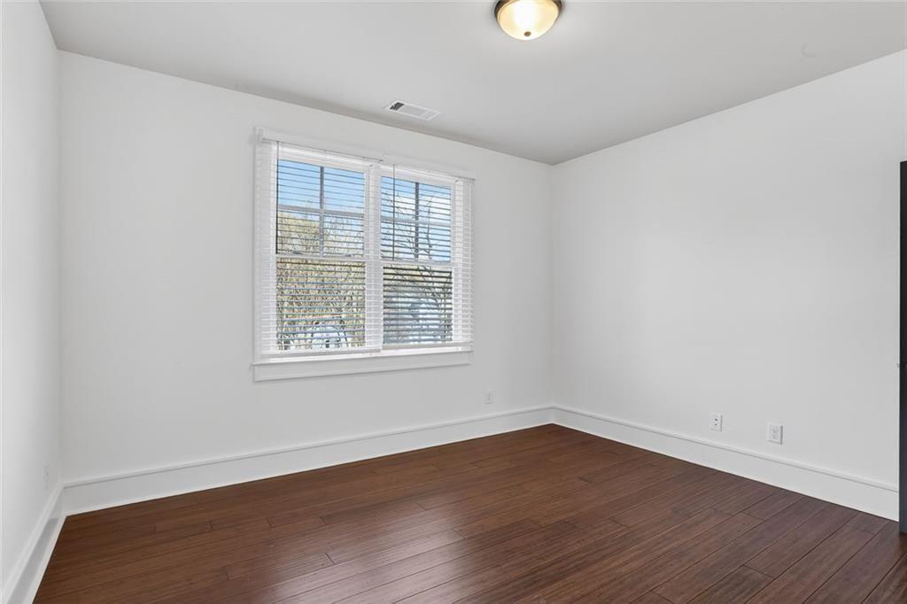 1311 Conway Road Decatur, GA 30030 - Photo 37 of 49 an empty room with wooden floor and windows