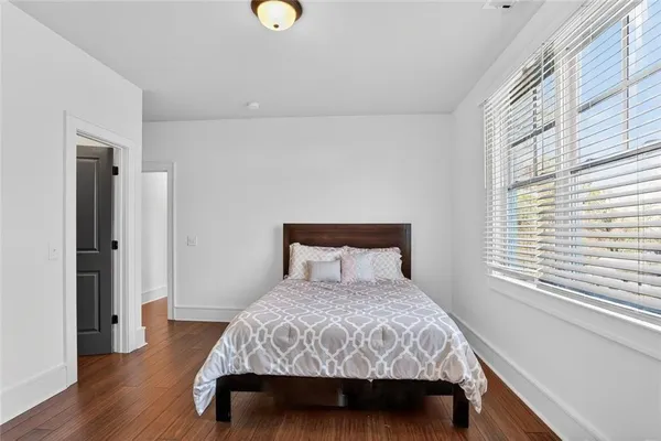 a bedroom with a bed and wooden floor