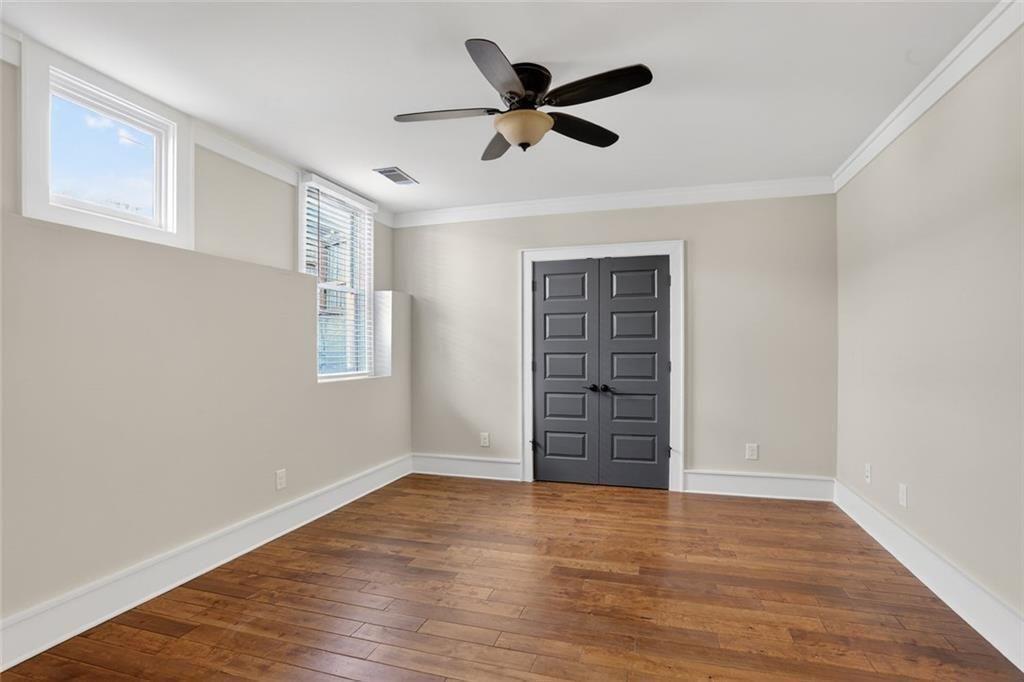 1311 Conway Road Decatur, GA 30030 - Photo 43 of 49 a view of empty room with wooden floor and ceiling fan