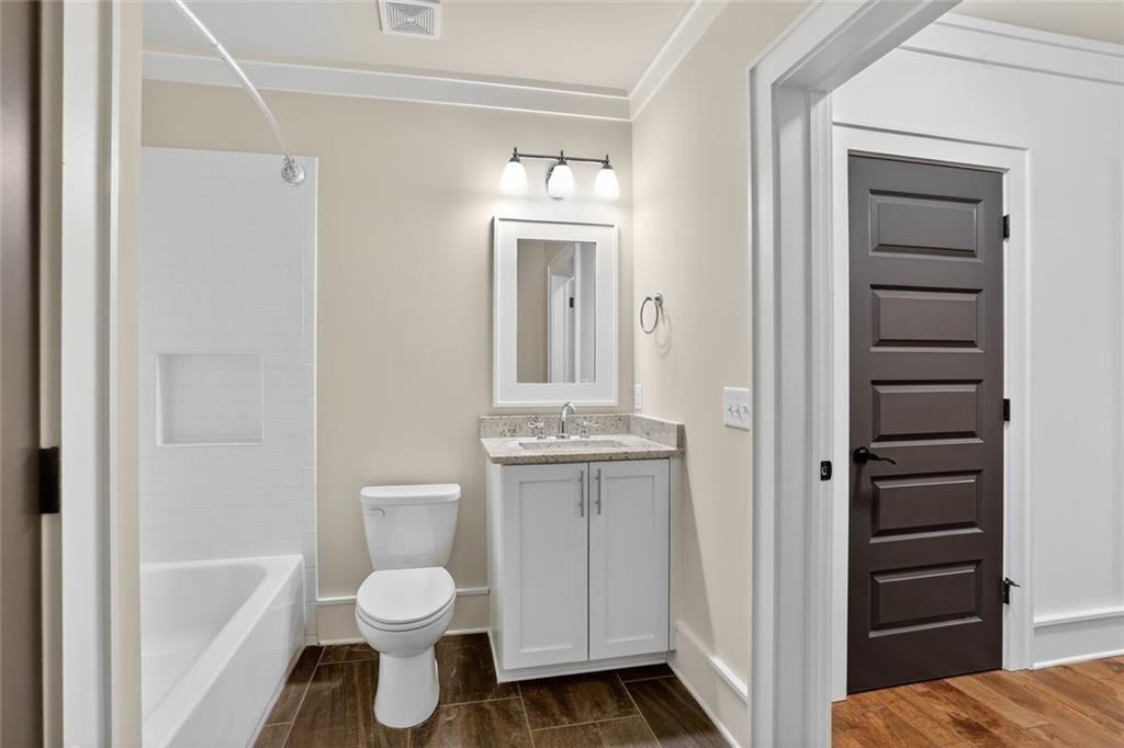 1311 Conway Road Decatur, GA 30030 - Photo 47 of 49 a bathroom with a toilet a sink and mirror