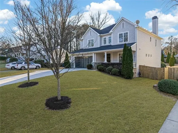 a house that has a tree in front of it