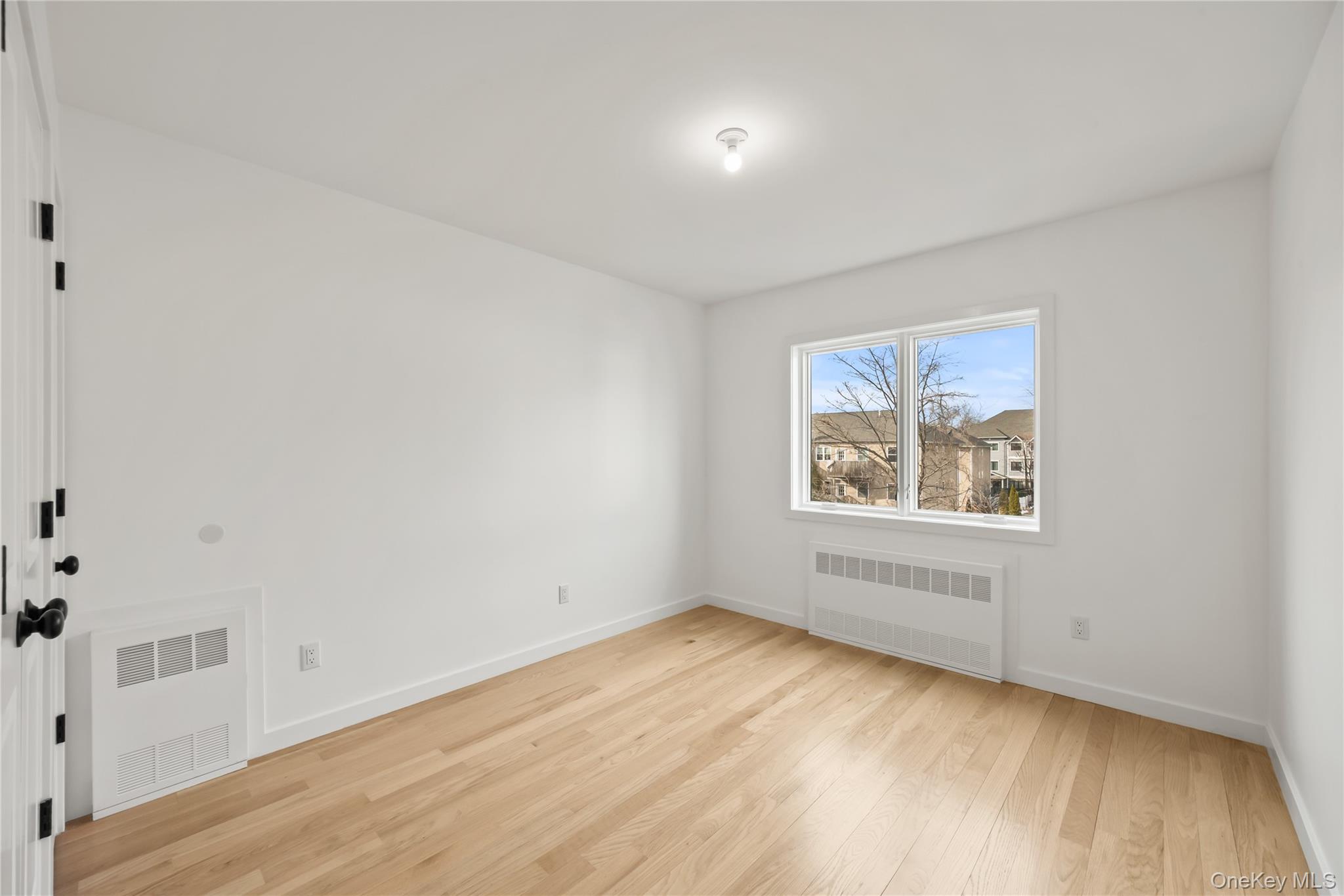 23 Singer Avenue, Unit 211 Spring Valley, NY 10977 - Photo 35 of 45 an empty room with wooden floor and window