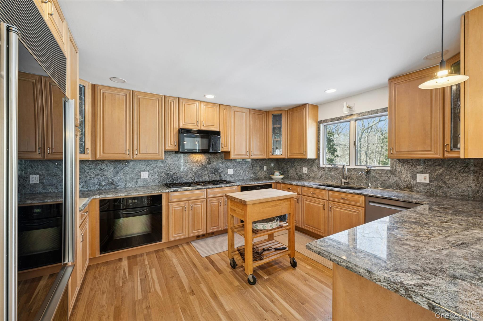 15 Rivers Road East Hampton, NY 11937 - Photo 12 of 33 a kitchen with granite countertop wooden cabinets a stove top oven and granite counter top