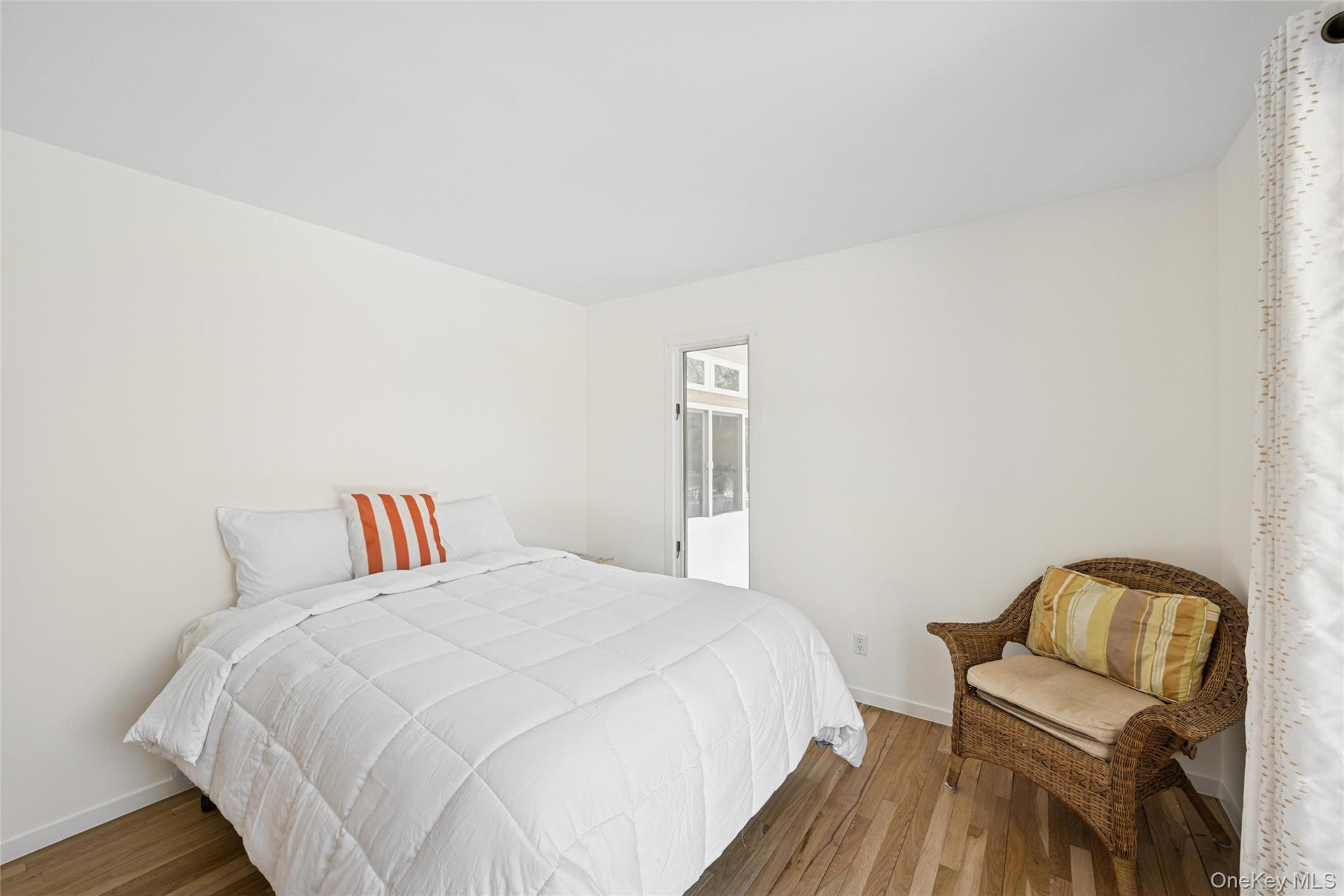 15 Rivers Road East Hampton, NY 11937 - Photo 19 of 33 a bedroom with a bed and wooden floor