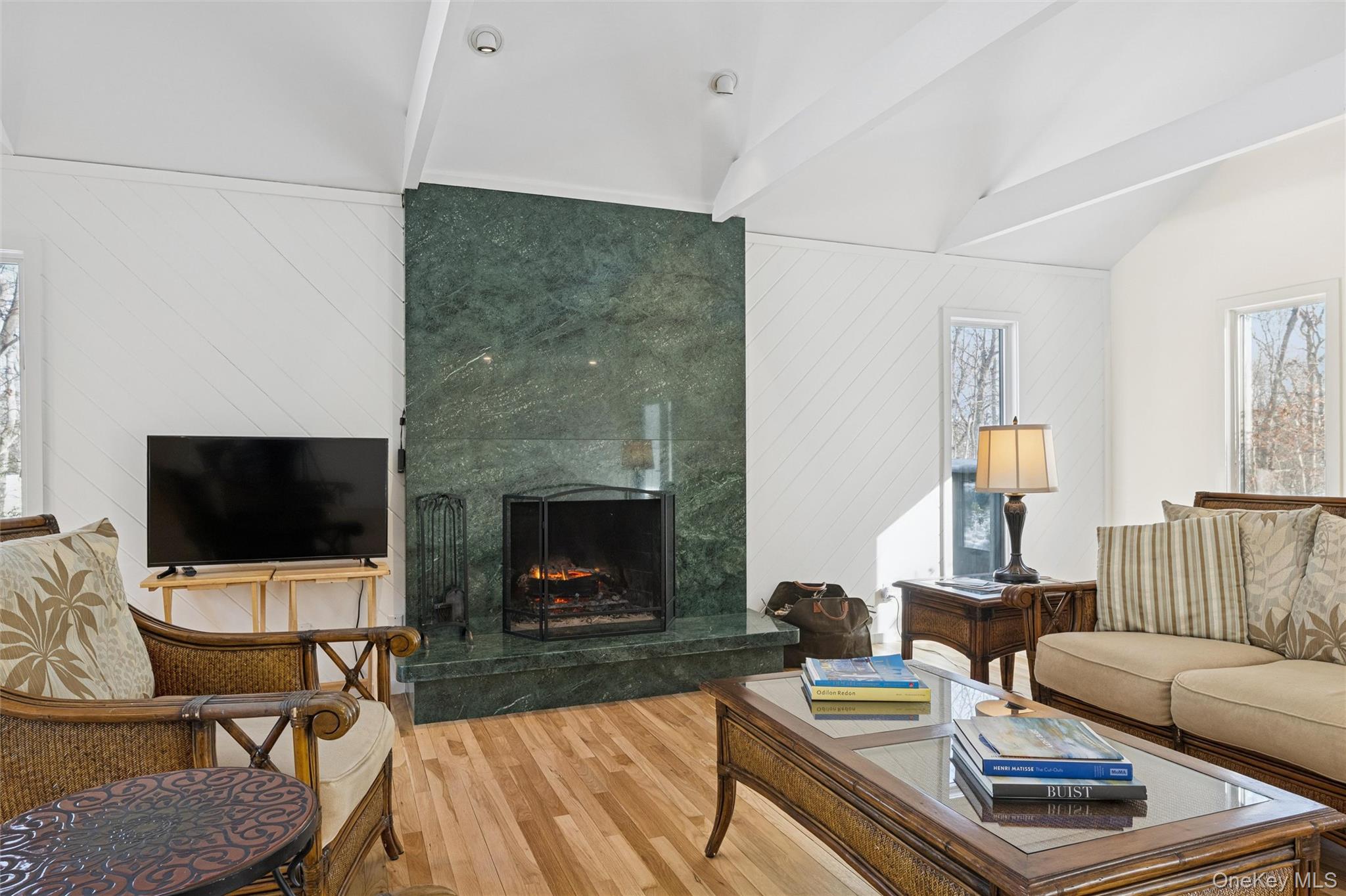 15 Rivers Road East Hampton, NY 11937 - Photo 3 of 33 a living room with furniture a flat screen tv and a fireplace