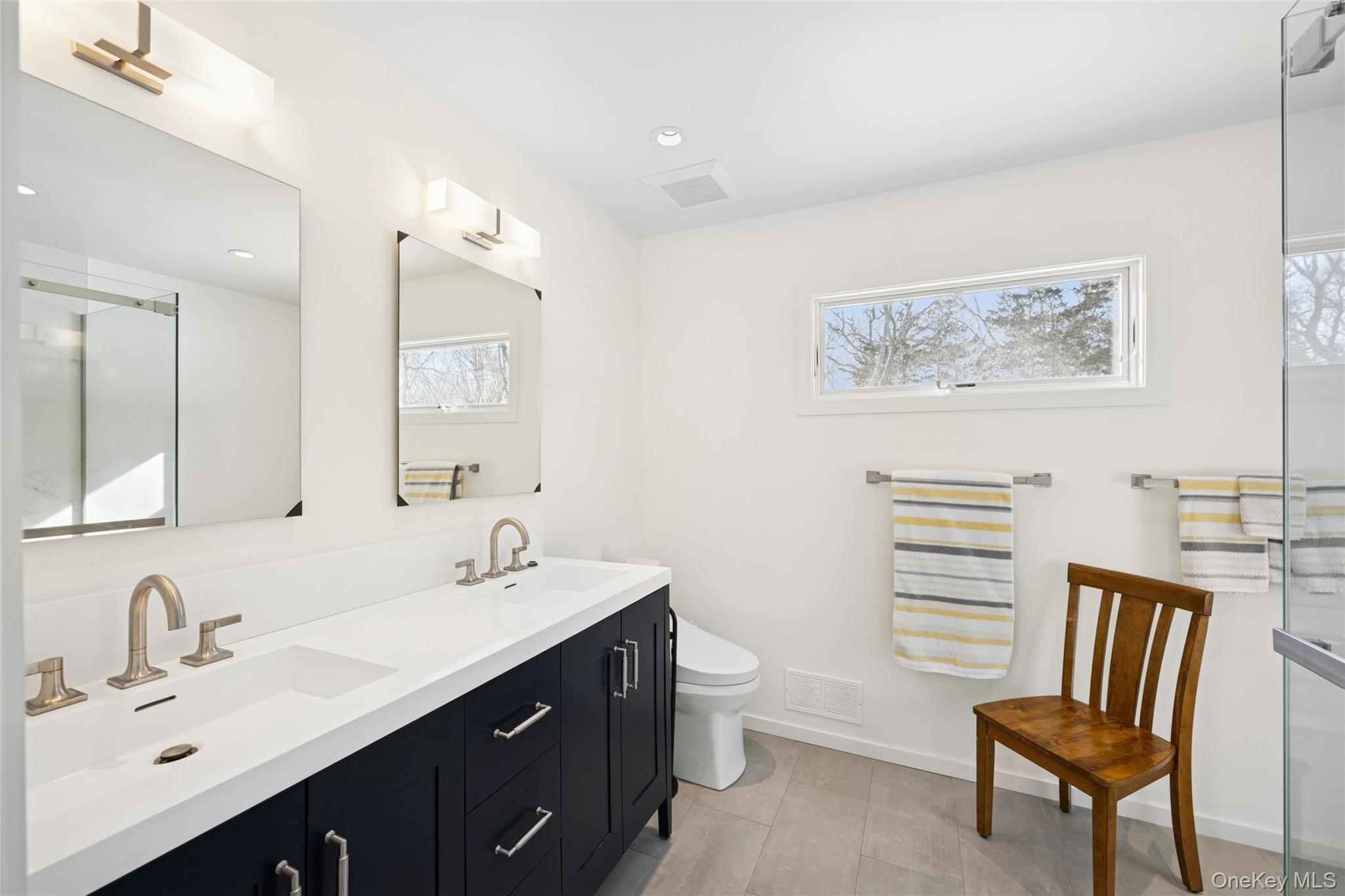 15 Rivers Road East Hampton, NY 11937 - Photo 32 of 33 a spacious bathroom with a double vanity sink toilet and a mirror