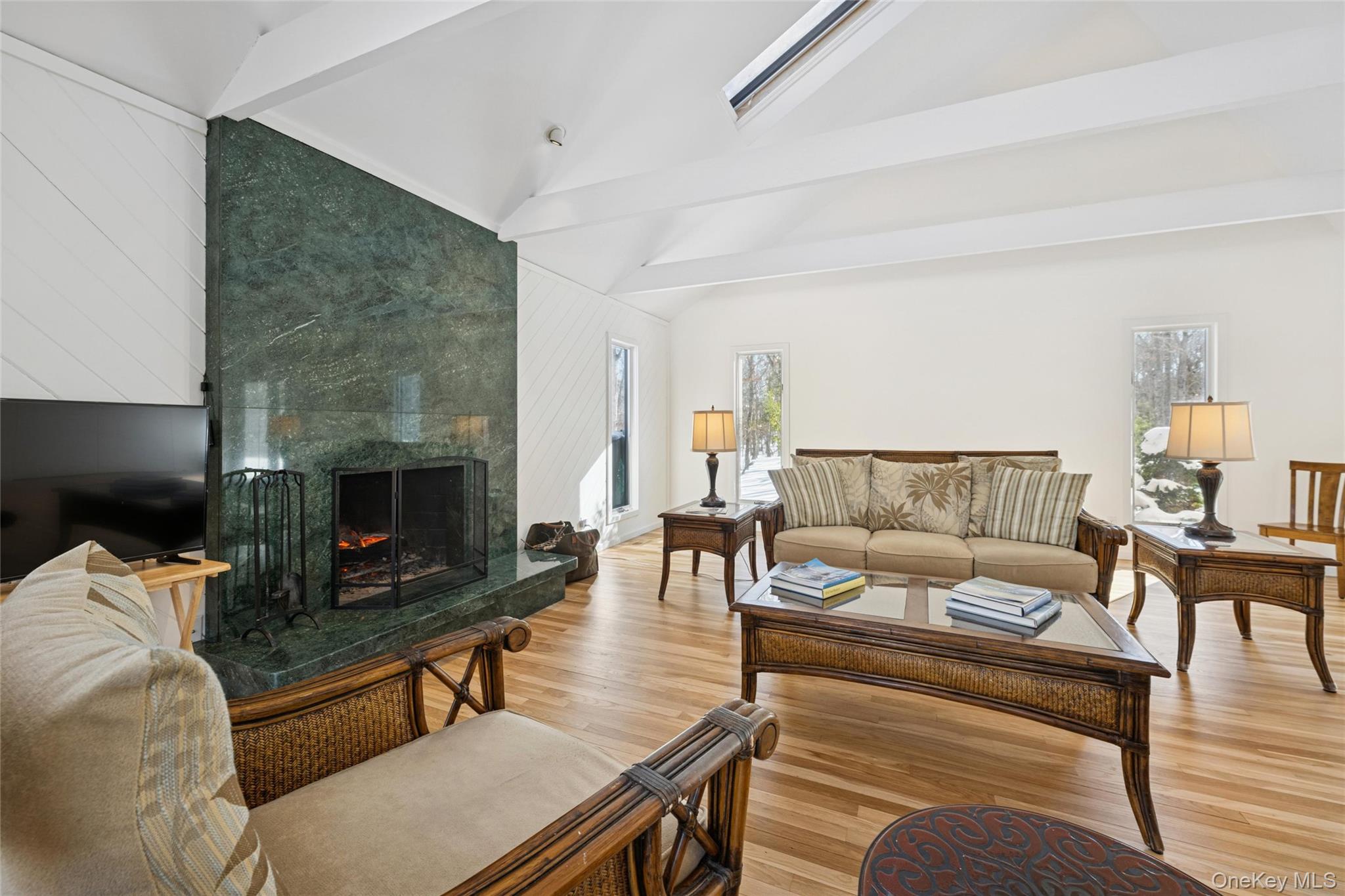 15 Rivers Road East Hampton, NY 11937 - Photo 9 of 33 a living room with furniture a flat screen tv and a fireplace