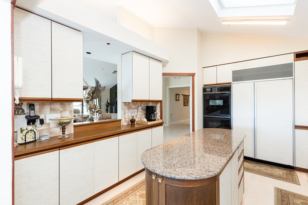 131 Nichols Road, Unit 8 Cohasset, MA 02025 - Photo 21 of 37 a kitchen with stainless steel appliances granite countertop a sink a stove and refrigerator