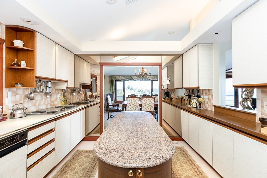 131 Nichols Road, Unit 8 Cohasset, MA 02025 - Photo 23 of 37 a large kitchen with granite countertop lots of counter top space and stainless steel appliances