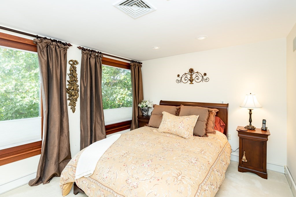 131 Nichols Road, Unit 8 Cohasset, MA 02025 - Photo 24 of 37 a bedroom with a large bed and a window