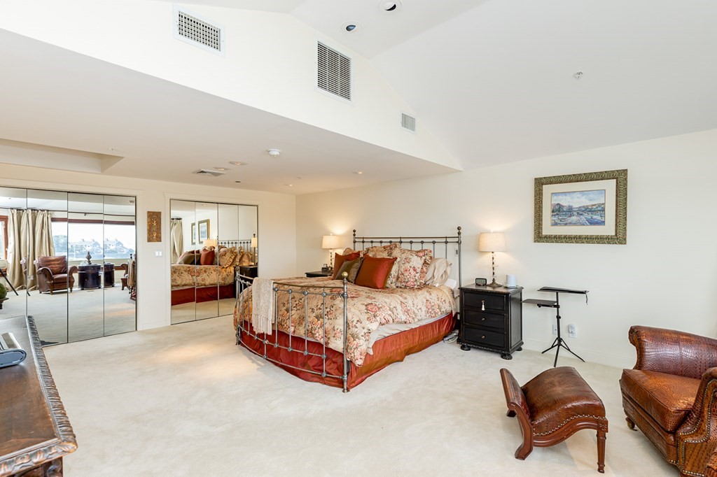 131 Nichols Road, Unit 8 Cohasset, MA 02025 - Photo 29 of 37 a spacious bedroom with a bed a table and chair