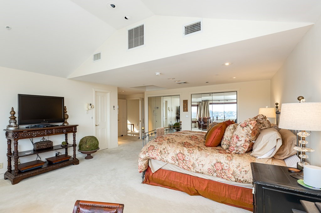 131 Nichols Road, Unit 8 Cohasset, MA 02025 - Photo 30 of 37 a bedroom with bed and large windows