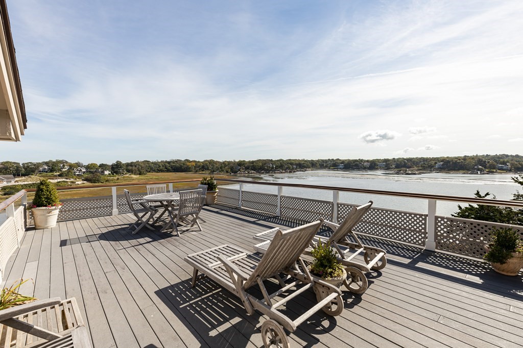 131 Nichols Road, Unit 8 Cohasset, MA 02025 - Photo 9 of 37 a view of a terrace with wooden floor and city view