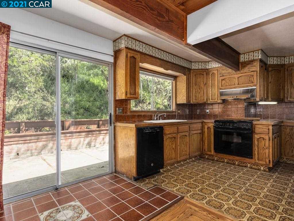 919 Janet Lane Lafayette, CA 94549 - Photo 12 of 31 a kitchen with stainless steel appliances granite countertop a stove a sink and a microwave