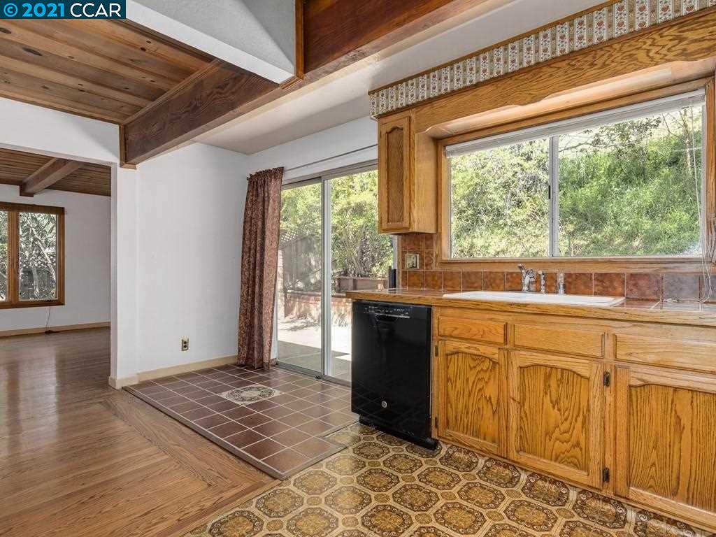 919 Janet Lane Lafayette, CA 94549 - Photo 13 of 31 a kitchen with stainless steel appliances granite countertop a stove a sink and a granite counter tops with white cabinets