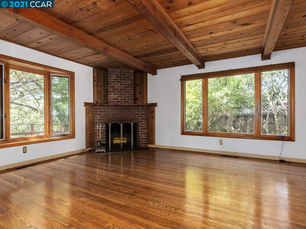 919 Janet Lane Lafayette, CA 94549 - Photo 9 of 31 a view of empty room with wooden floor and fireplace