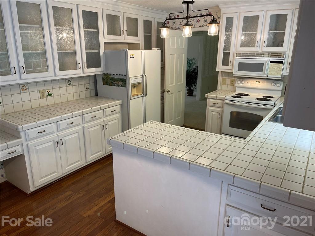 170 Nottingham Road Salisbury, NC 28147 - Photo 12 of 27 a kitchen with a refrigerator sink and cabinets